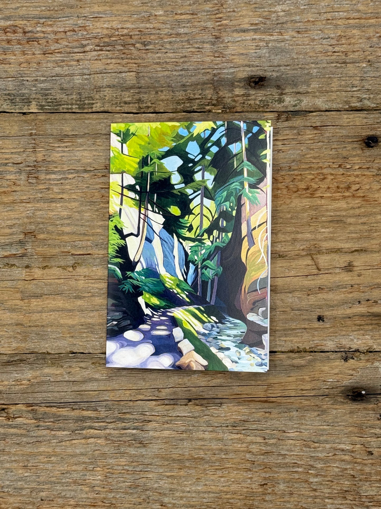 Painting of a forest scene on a wooden surface