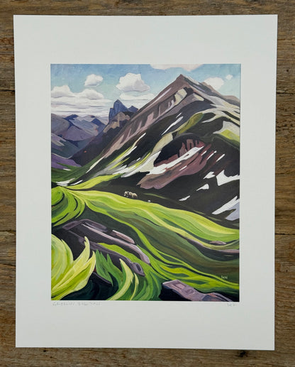 Painting of a mountain landscape with green valleys and purple mountains on a wooden surface.