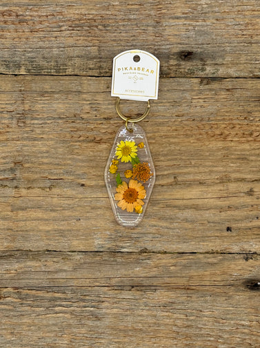 Keychain with pressed flowers on a wooden surface