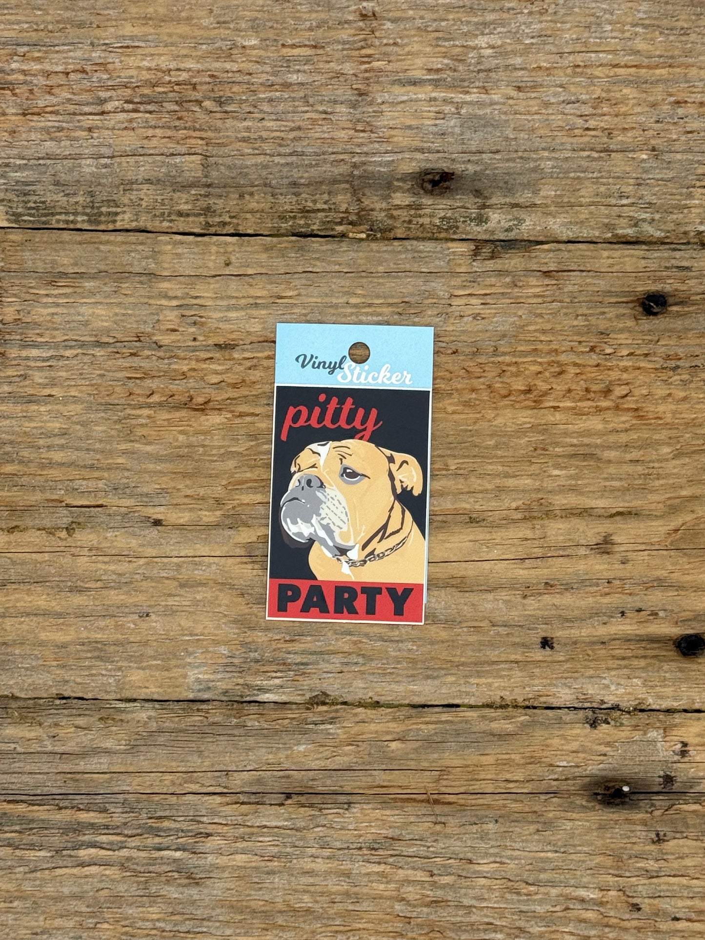 Sticker with a dog design and text on a wooden surface