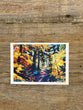 Colorful forest painting on a wooden surface