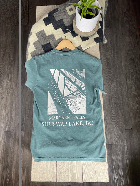 A t-shirt with a white graphic of a bridge and the text 'MARGARET FALLS SHUSWAP LAKE, BC'.