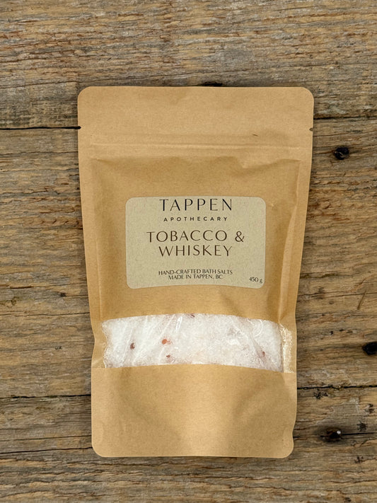 Tappen Apothecary Tobacco & Whiskey bath salts packaging on a wooden surface