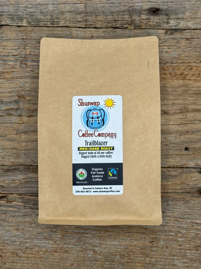Kraft paper coffee bag with Shuswap Coffee Company label on a wooden surface