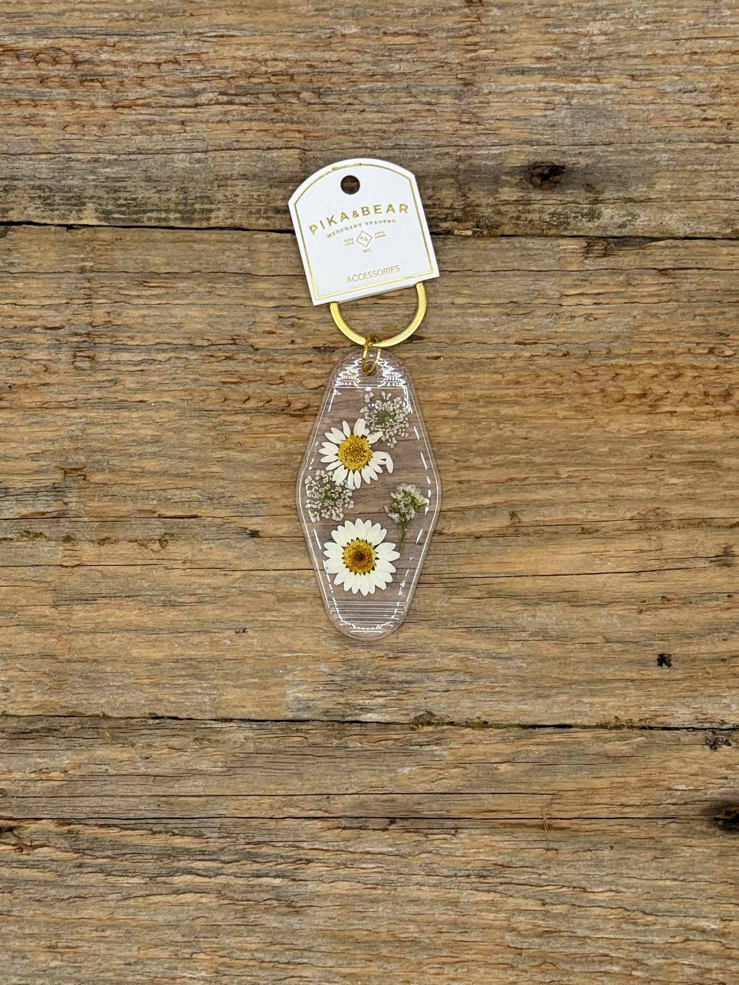 Keychain with pressed flowers on a wooden surface