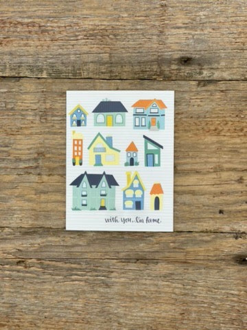 Card with colorful houses on a wooden surface