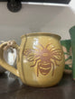 Ceramic mug with a bee design on a white background