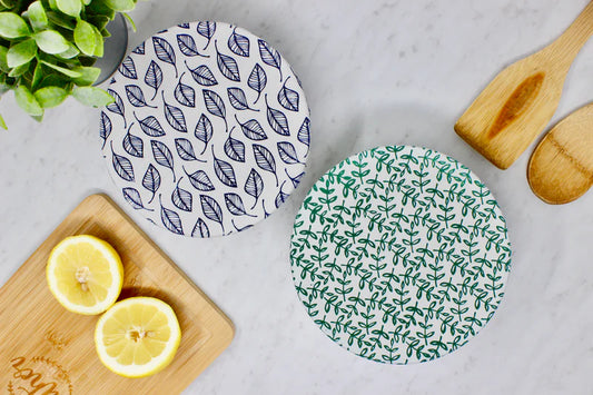 Reusable fabric bowl covers. one blue leaf pattern and other with a green speckled design. 